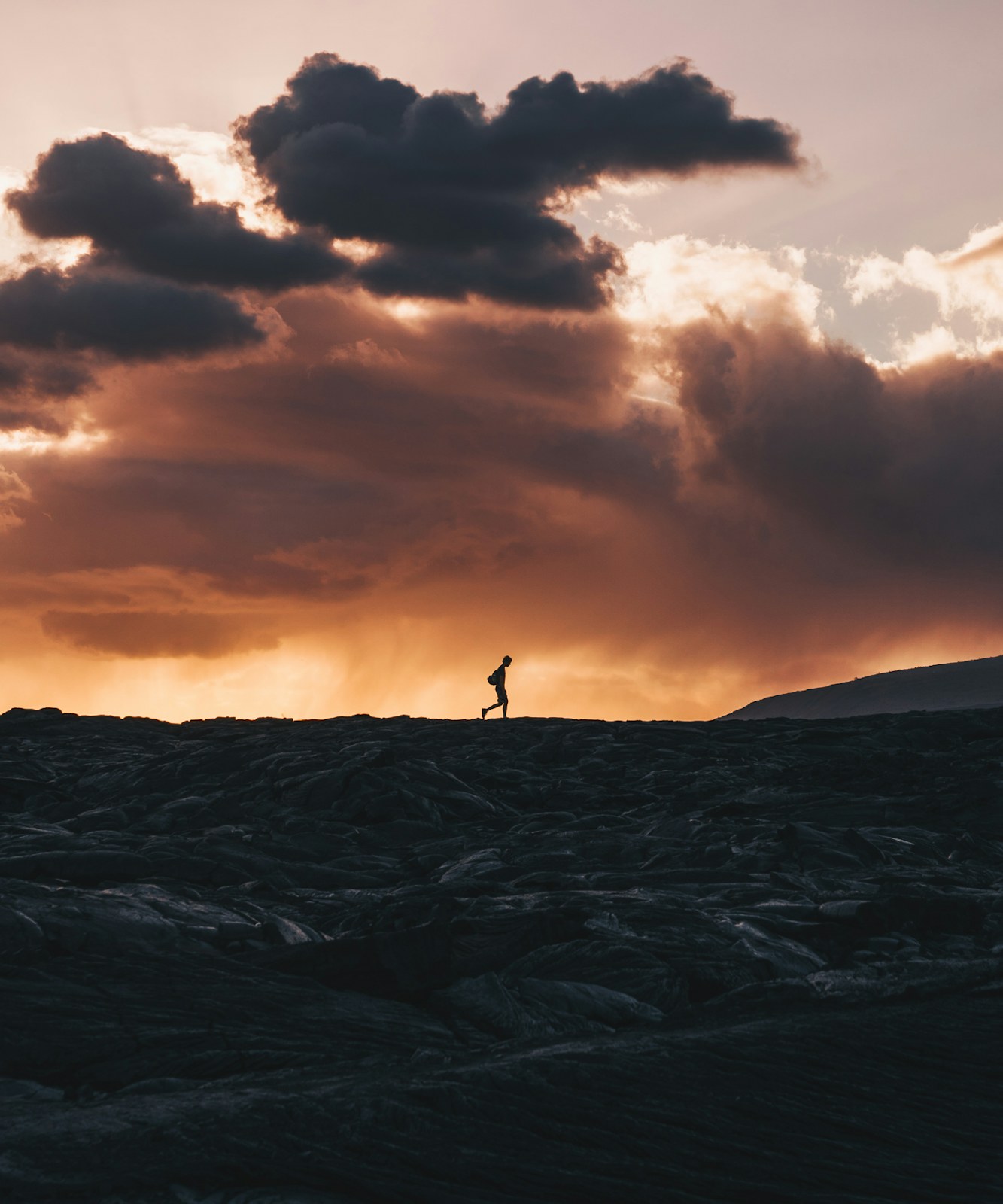 A lone figure walks a clear path toward a distant horizon